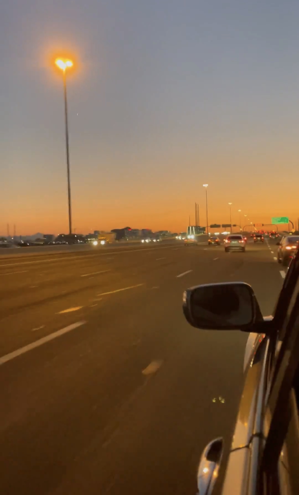 bright tangerine orange faded to blue sunset along the highway in Phoenix, Arizona
