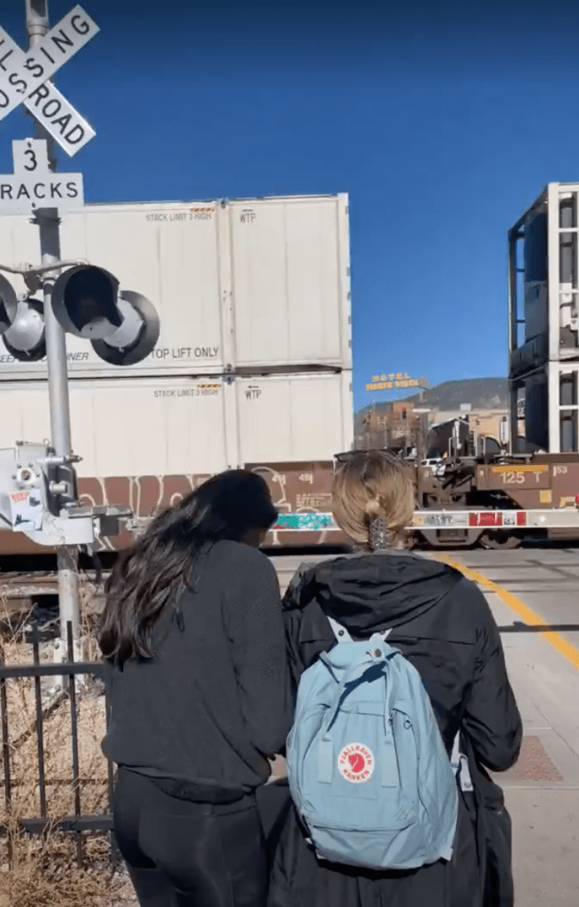 two girls waiting for the train to pass in Downtown Flagstaff