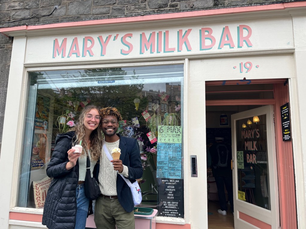 two friends smiling holding gelato in Edinburgh, Scotland