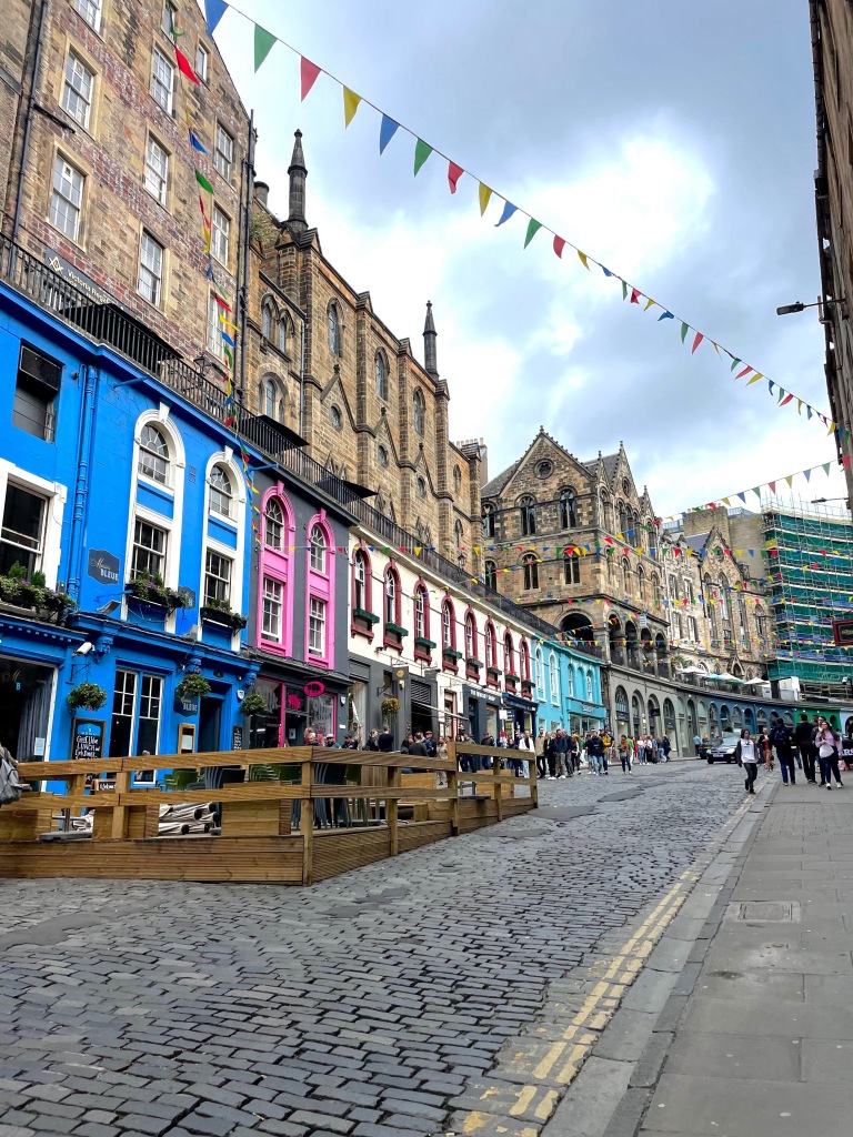 colorful buildings along the cobble road of Victoria Street in Scotland