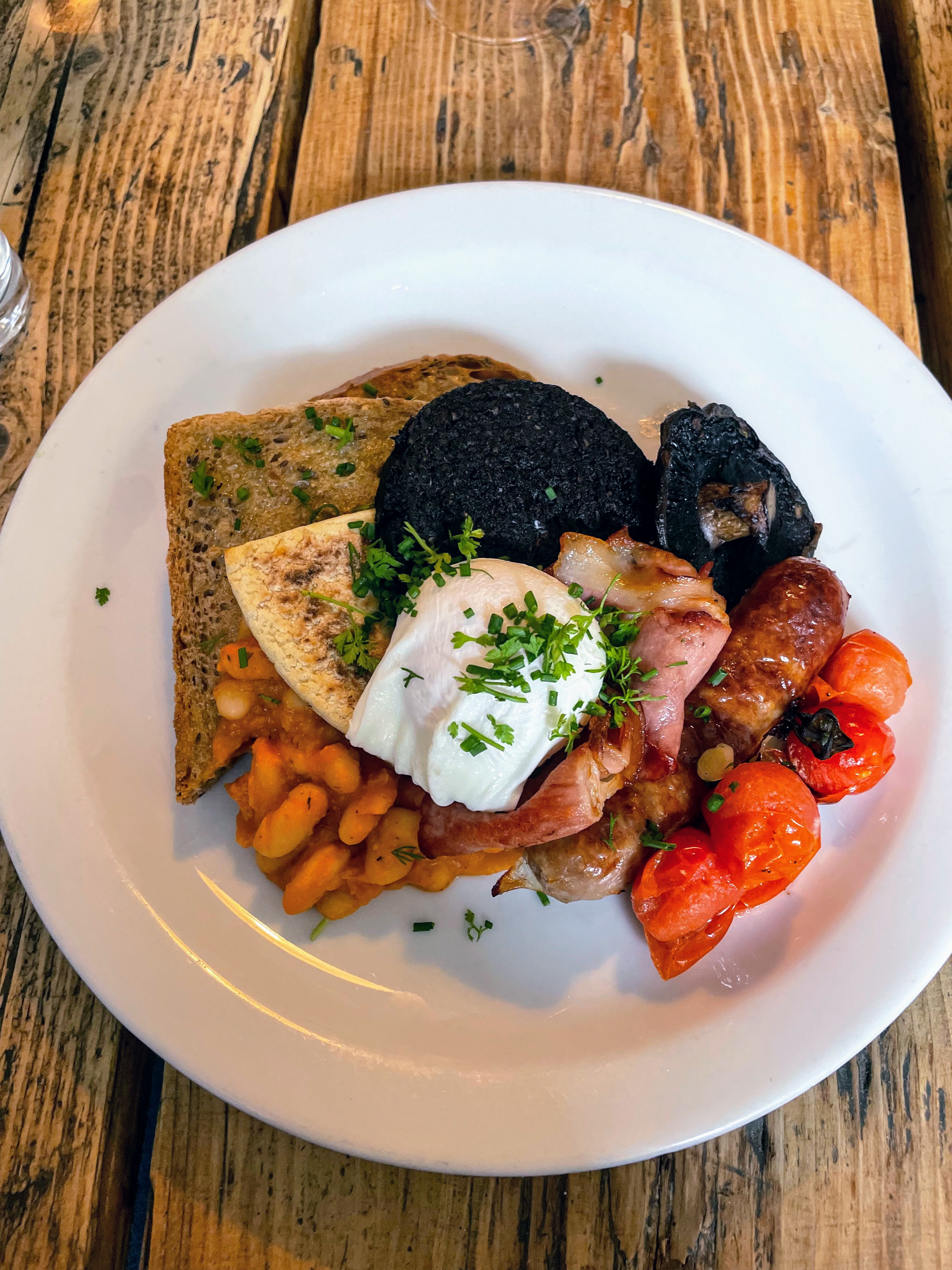 A plate of a classic a Scottish breakfast with black pudding and beans on toast in Edinburgh, Scotland