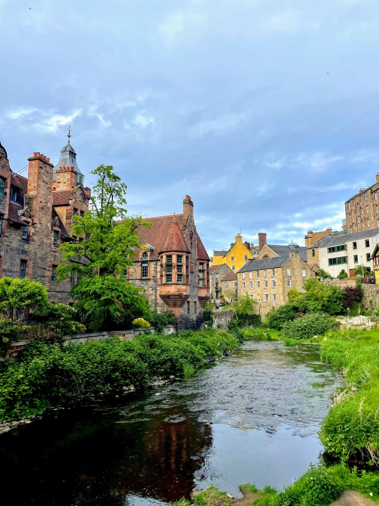 a stream surrounded by old houses in Edinburgh, Scotland