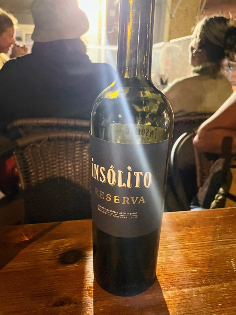 Bottle of insólito reserva portugues red wine on a dining table at an Italian restaurant in Lisbon