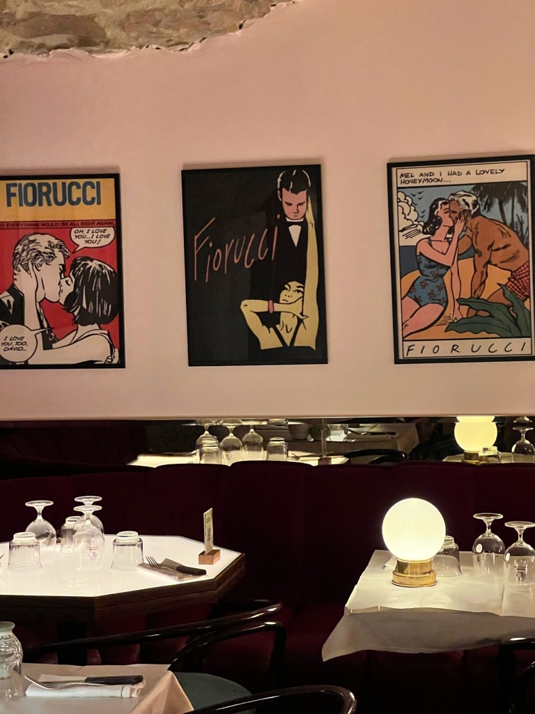 Italian comic and animated art on a wall in an Italian restaurant in France