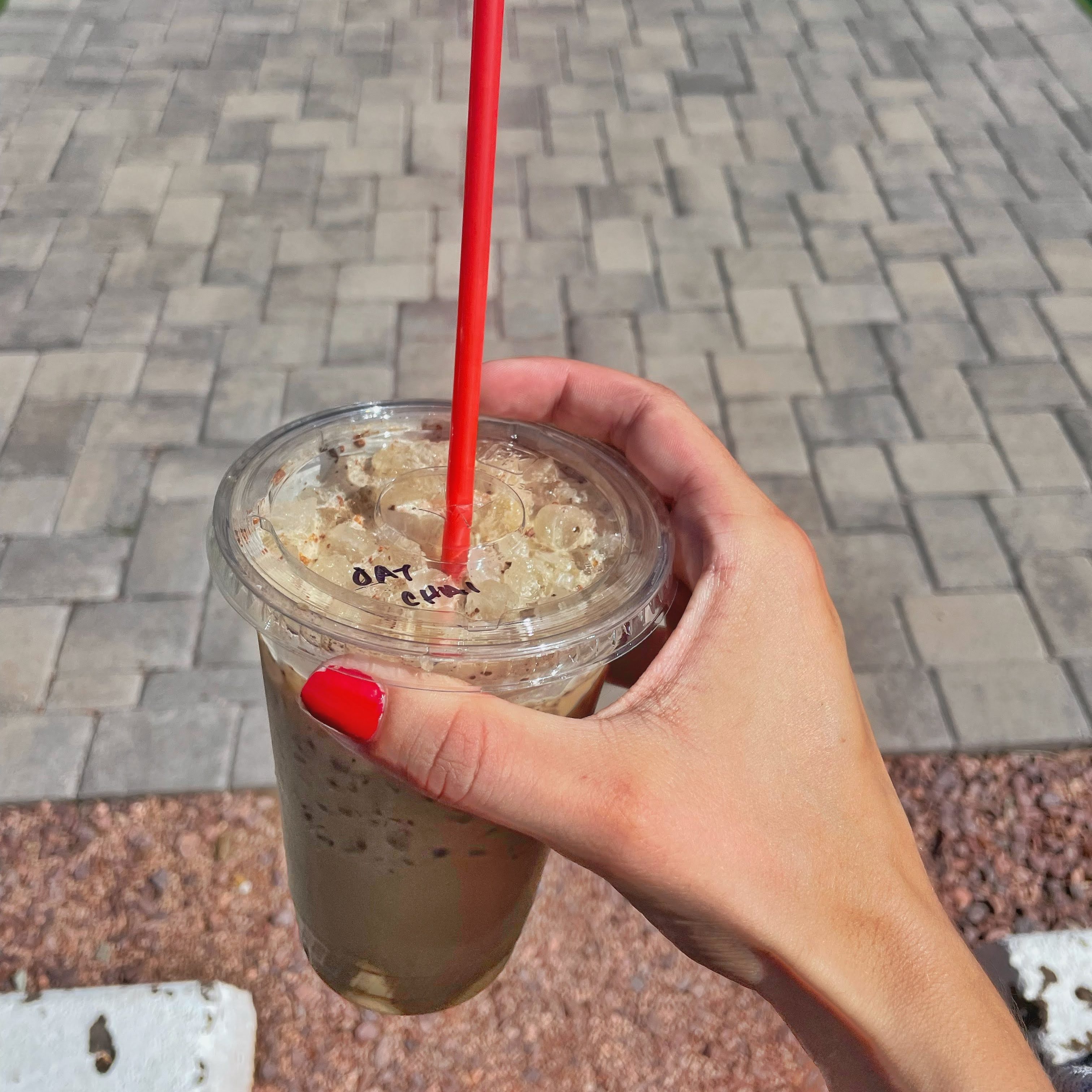 hand holding and iced oat milk chai latte in Strawberry, Arizona