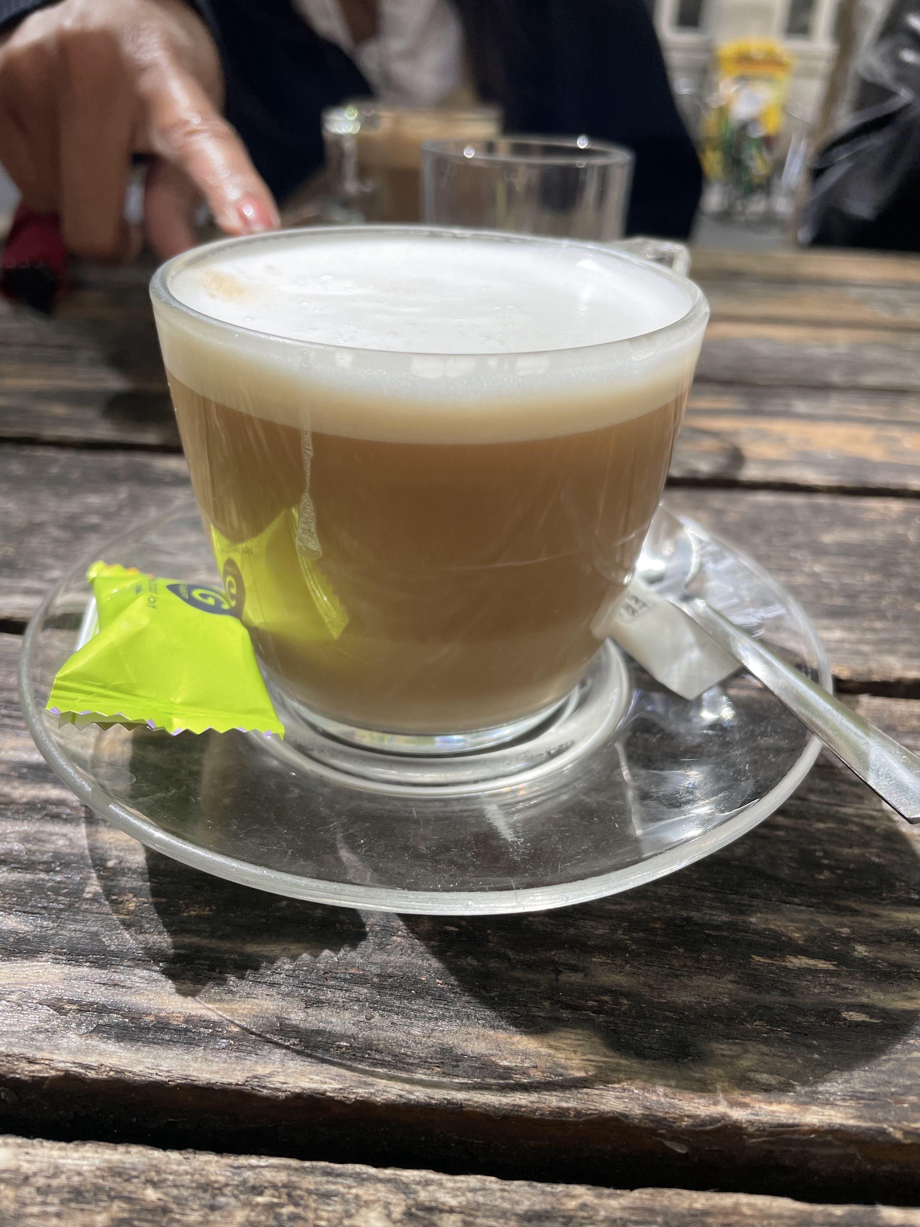 A perfectly made cappuccino, with a layer of espresso, milk, and foam, from a café in France