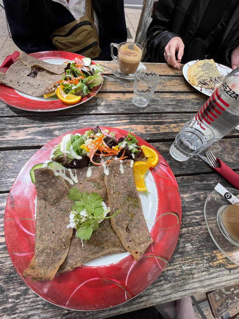 A classic galette bretonne on a red plate from a café in Lyon, France