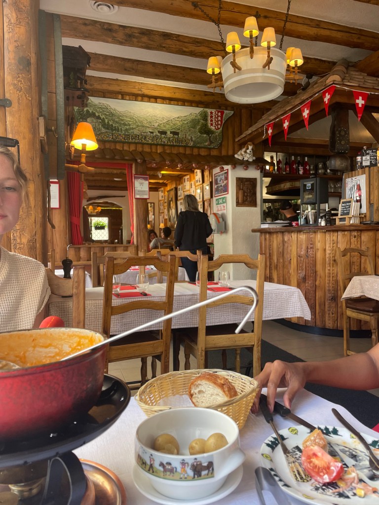 A rustic, Swiss restaurant that makes you feel like you're in a cabin in the Alps, with fondue, bread, and potatoes on the table