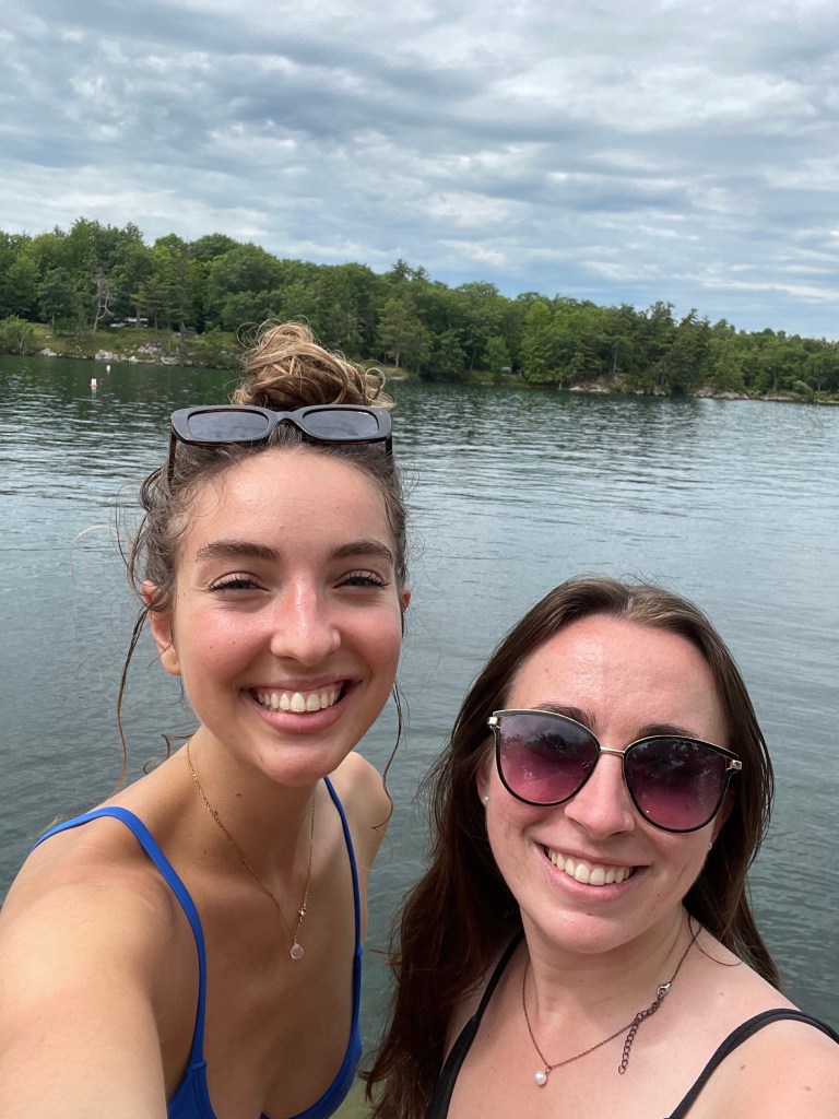 Two girls taking a selfie in swim suits while on the Saint Lawrence River in Wellesley Island