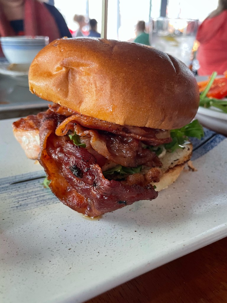 Decadent salmon BLT on a toasted bun at a lakeview restaurant in Skaneateles, New York