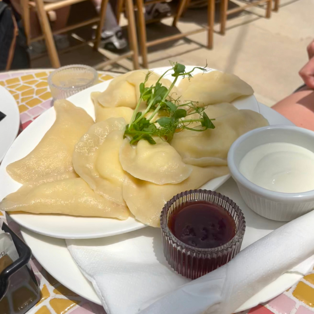 Dessert perogies filled with ricotta with a side of jam and yogurt at a cute outdoor cafe on the island of Malta