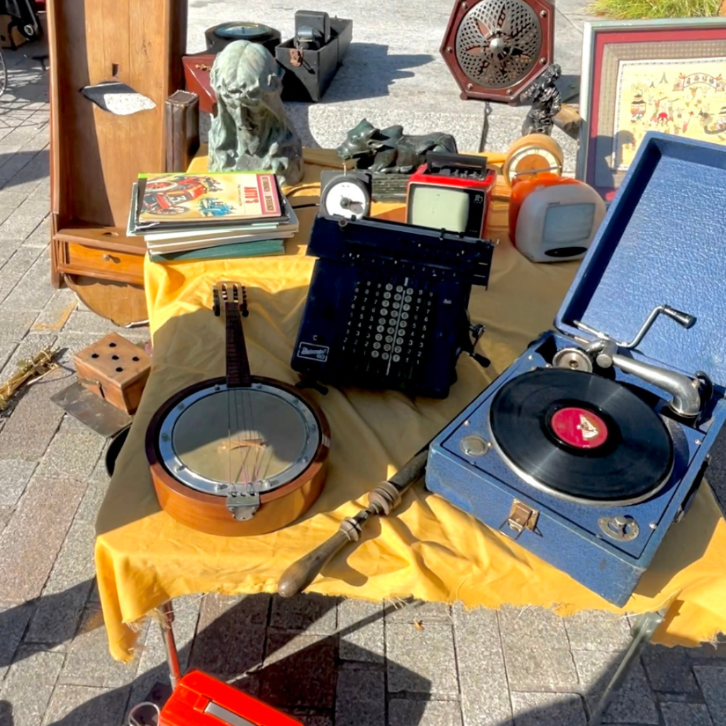 A banjo and vintage record player at a flea market in Bruges, Belgium
