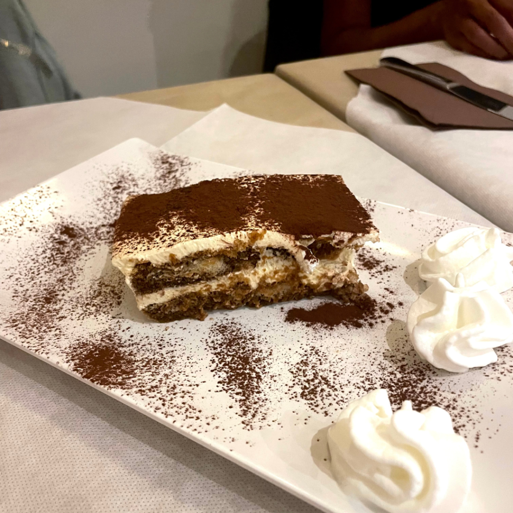 A decadent slice of tiramisu topped with espresso powder at an Italian restaurant on the Island of Malta,