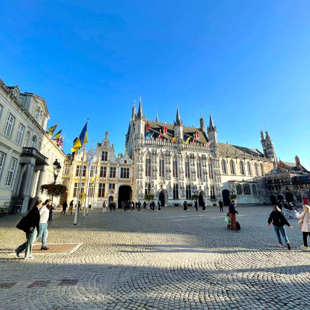 The gorgeous medieval and gothic style government buildings in Bruges, Belgium during golden hour