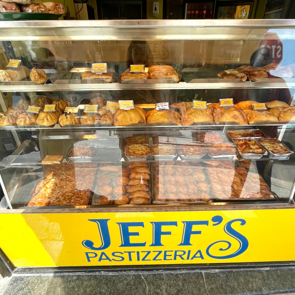 The pastry case of Jeff's Pastizzeria featuring many different Maltese street food items