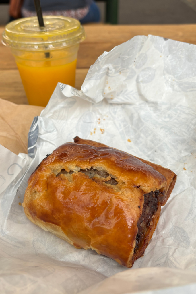 The famous sausage roll from Borough Market in London, England, perfectly baked to a golden pastry dough exterior and filled with a thick portion of heavenly sausage.