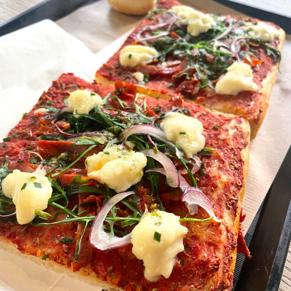 Two slices of a delicious homemade pizza from a boulangerie in Menton, France