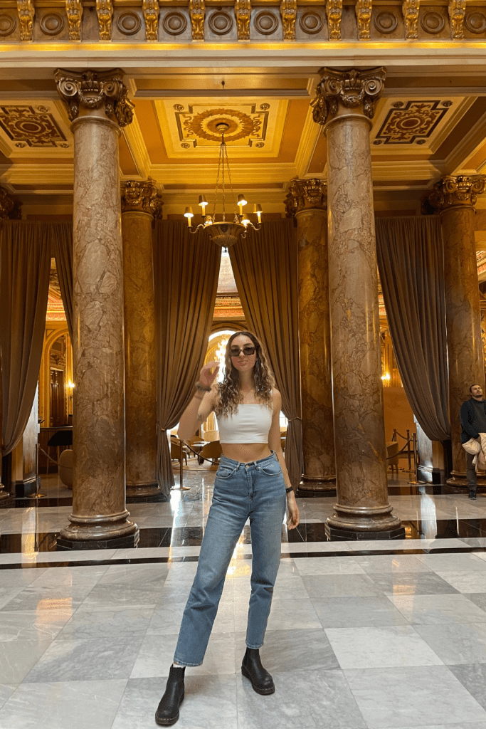 A woman posing inside the Monte Carlo Casino in Monaco