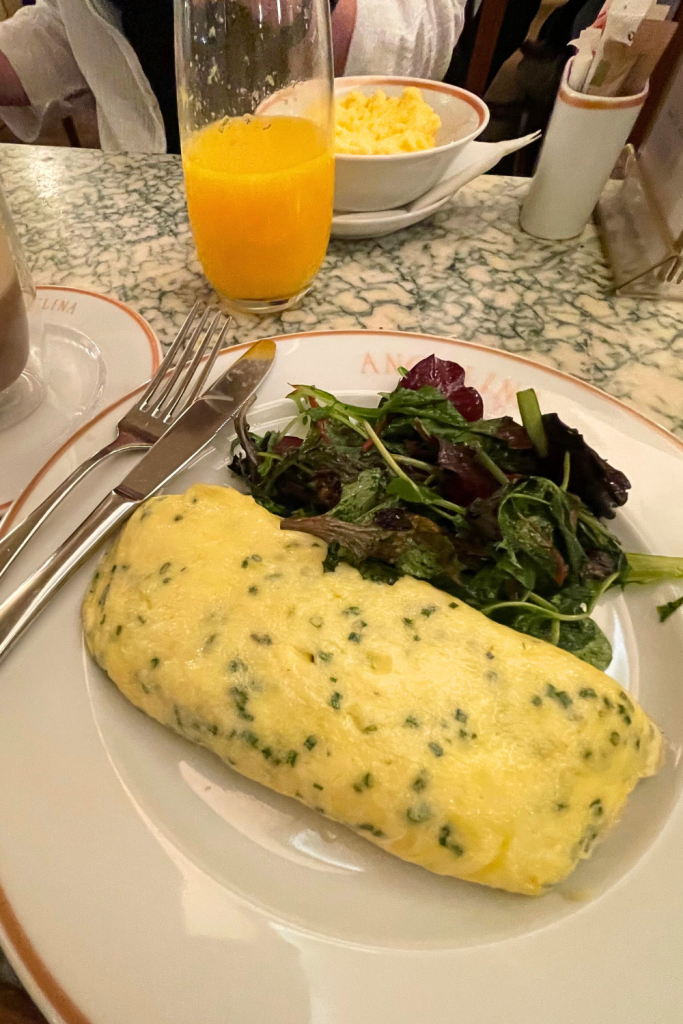 An omelette with herbs and a side salad for brunch at Angelina's Café in Paris