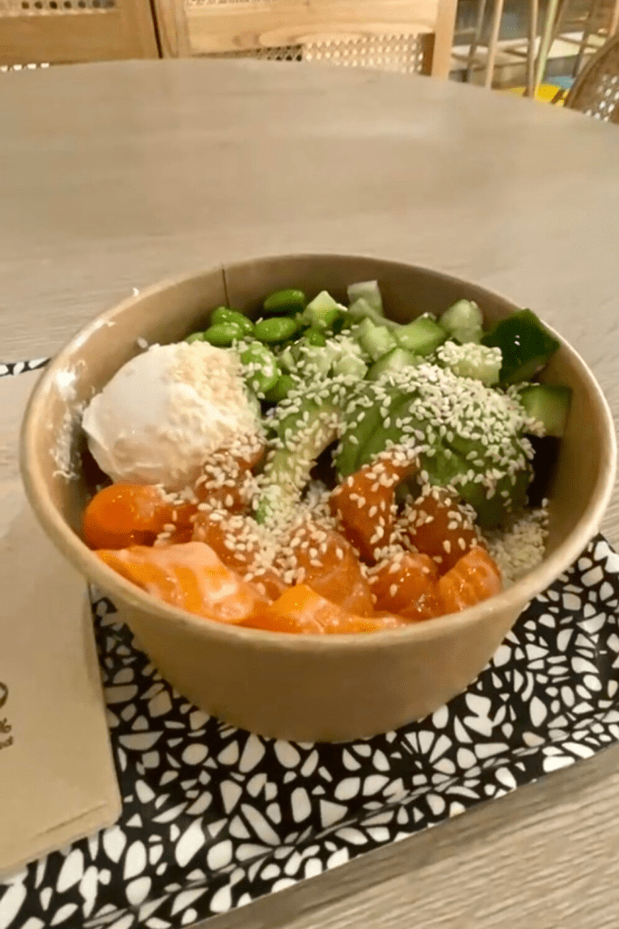 Poke bowl topped with salmon, cream cheese, edamame, avocado, and sesame seeds from a restaurant in Nice, France