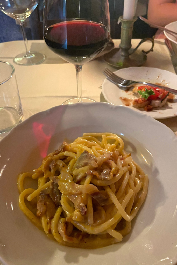 A delicious bowl of pasta Carbonara at a romantic restaurant in Florence, Italy