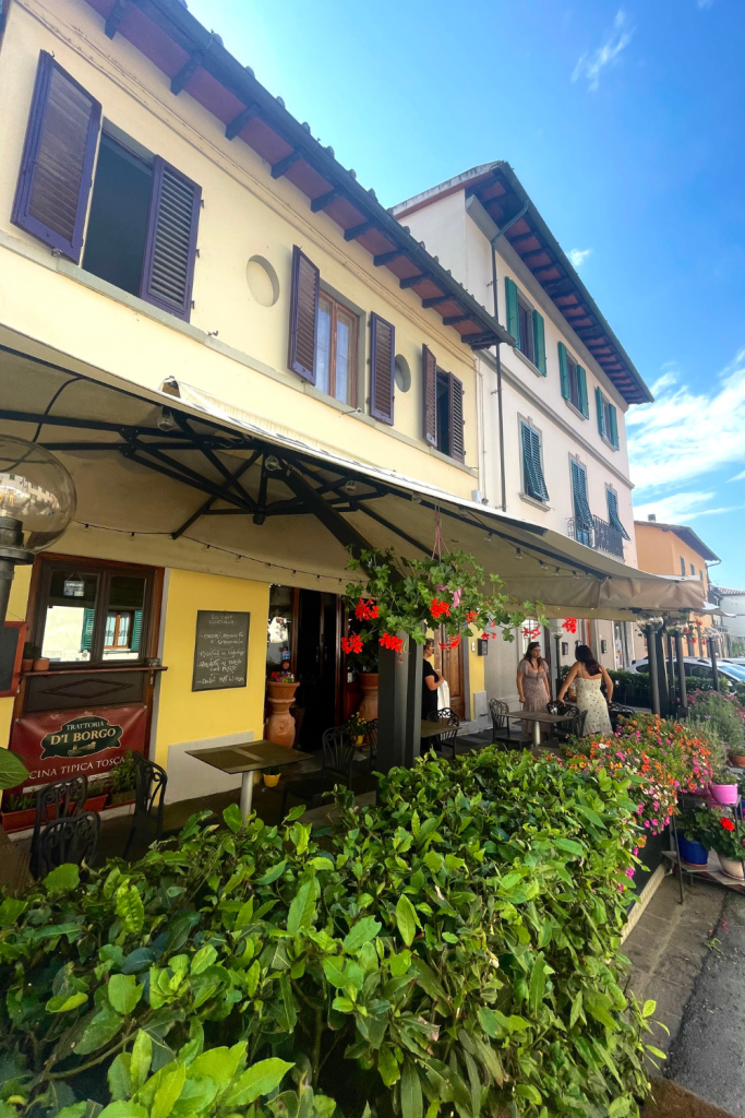 A family owned trattoria from the 1900's in a small town in Greve, Italy covered with beautiful flowers in an old house.