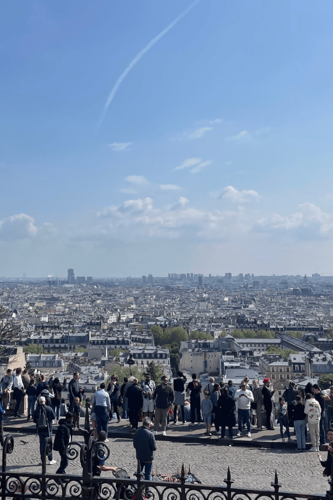 An expansive view of Paris from Sacre Cœur in Montmartre on a clear, sunny day.