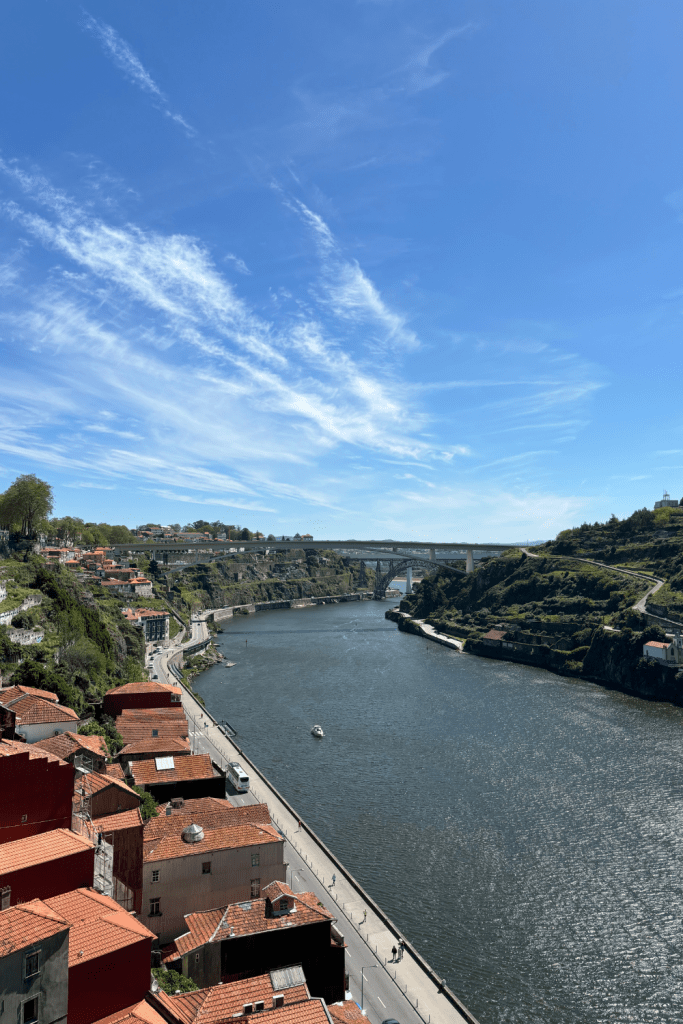 View of the Douro River from high above at the Ponte Luís I bridge in Porto on a sunny day.