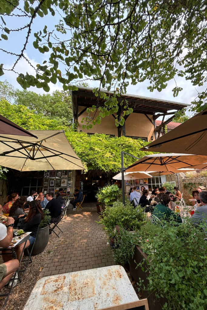 A restaurant in Giverny, France with lots of terrace seating on a sunny day.
