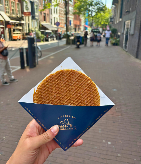 A freshly made stroopwafel from the oldest bakery in Amsterdam, the Netherlands on a sunny, summer day