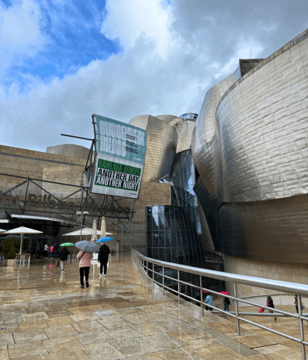 Entrance to the Guggenheim Bilbao museum after the rain with the clouds partings