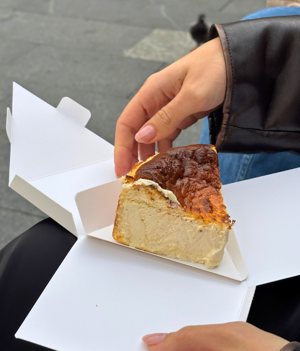 Opening up the box of the basque cheesecake in Nuevo Plaza in Bilbao, Spain